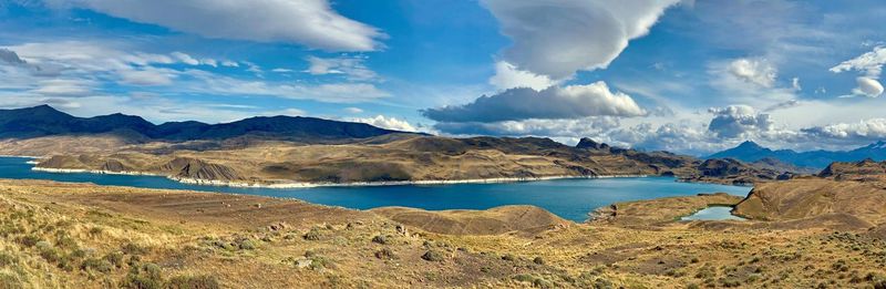 Panoramic view of sea and mountains against sky