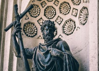 Statue against wall and building