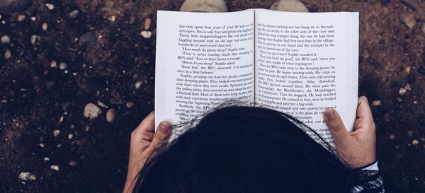 High angle view of woman reading book