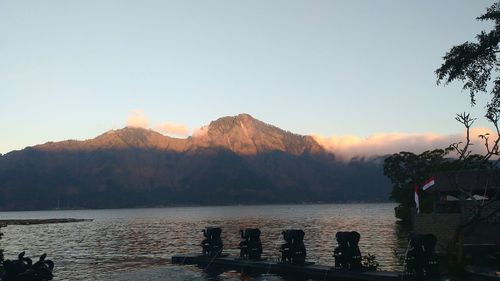 Scenic view of lake and mountains against clear sky