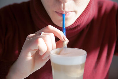 Close-up of woman drinking milkshake