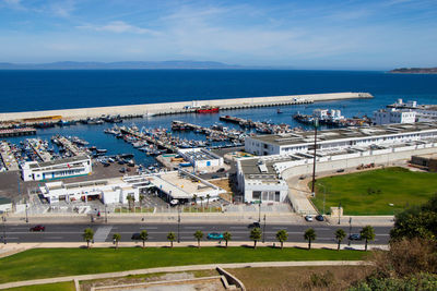 High angle view of city by sea against sky