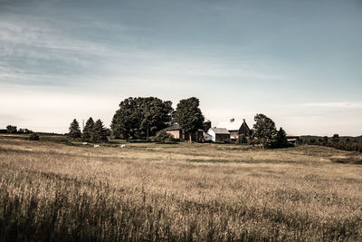 Built structure on field against sky