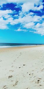 Scenic view of beach against blue sky