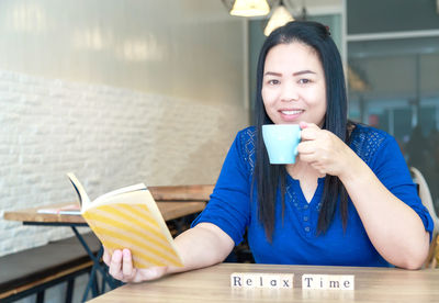 Young woman holding coffee cup