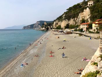 People on beach against sky