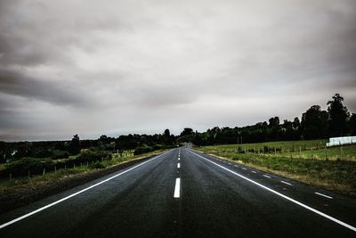 Country road against sky