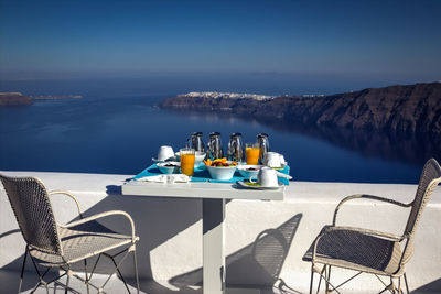 Chairs and table against calm blue sea