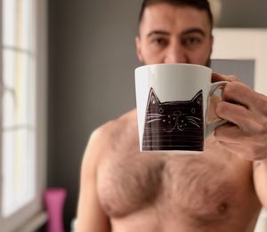 Portrait of young man drinking glasses