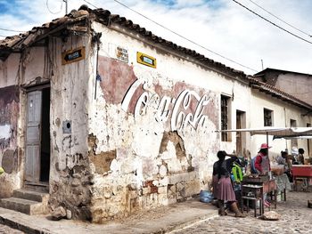 People on old building in city