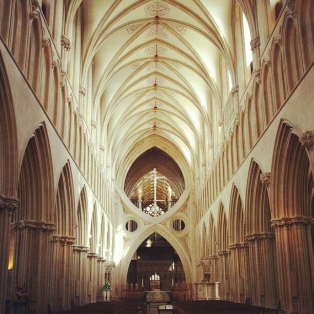 indoors, arch, architecture, ceiling, interior, built structure, place of worship, religion, church, spirituality, corridor, diminishing perspective, pew, history, architectural column, architectural feature, the way forward, illuminated