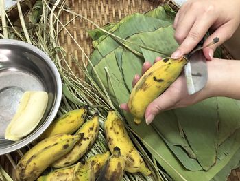 High angle view of person hand holding banana