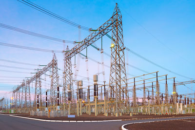 Low angle view of electricity pylon against sky