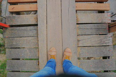 Low section of person standing on wooden floor