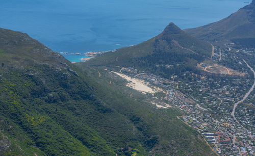 High angle view of townscape by sea against sky