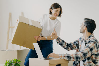 Couple with cardboard boxes at new home