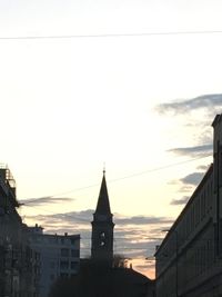 Low angle view of buildings against sky at sunset