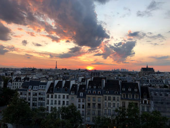 View of buildings against cloudy sky during sunset