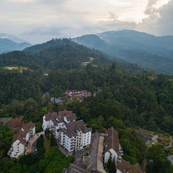 High angle view of townscape by mountain against sky