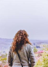 Woman standing against sky