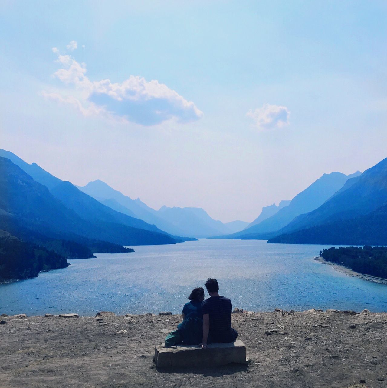 water, mountain, tranquility, tranquil scene, scenics, mountain range, sky, beauty in nature, sea, lake, sitting, nature, relaxation, rock - object, idyllic, leisure activity, rear view, men