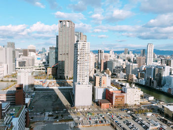 High angle view of modern buildings in city against sky