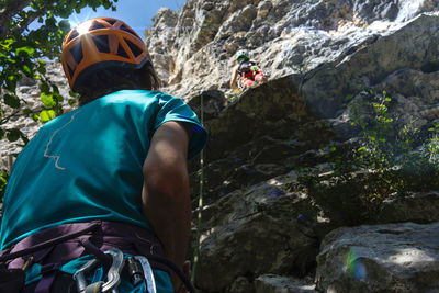 Two climbers and a reflection in the helmet