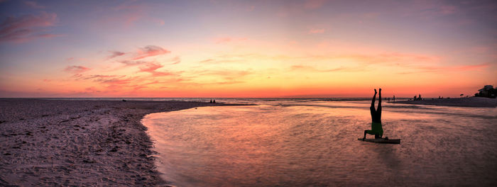 Scenic view of beach against sky during sunset