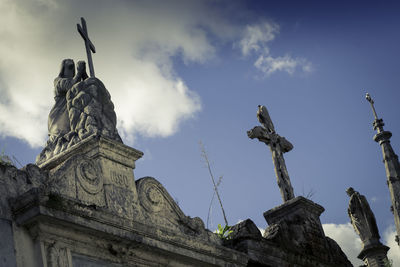 Low angle view of statue against cloudy sky