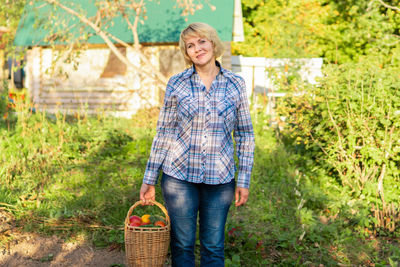 Mid adult man standing in basket