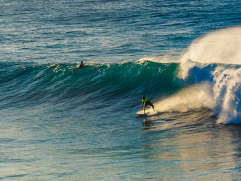 People surfing in sea