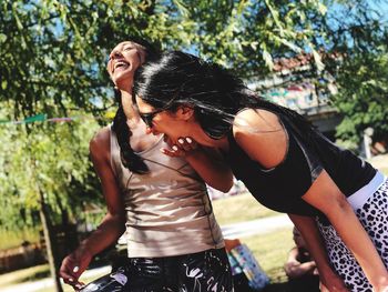 Smiling young woman standing outdoors