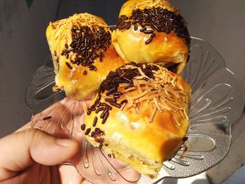 Close-up of hand holding cake