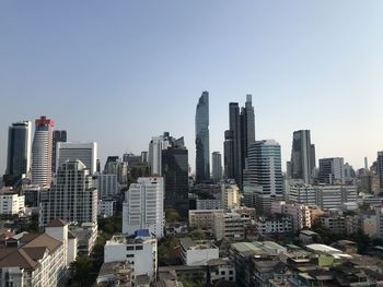 Modern buildings in city against clear sky