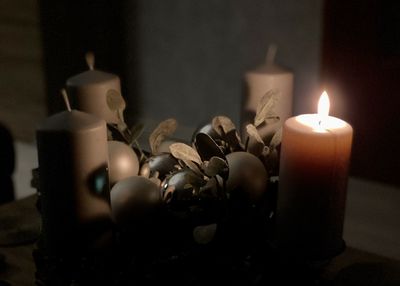 Close-up of burning candles on table