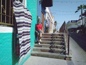 Man walking on staircase against building