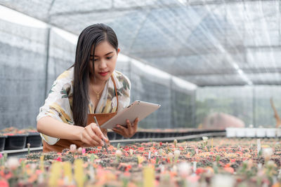 Young woman looking away while using mobile phone