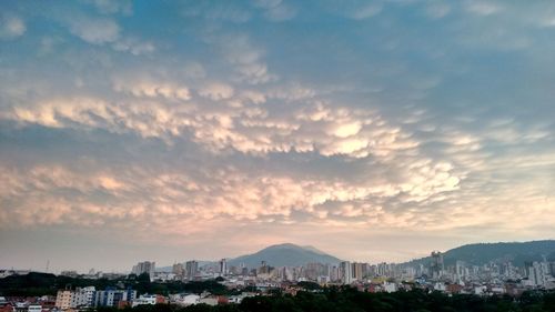 Cityscape against cloudy sky