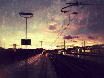 Railroad tracks against sky during sunset