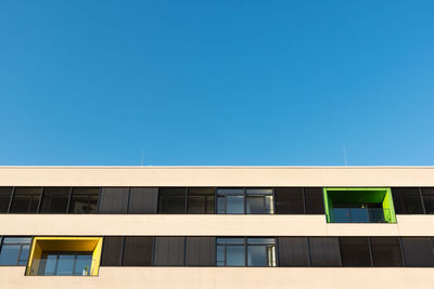 Low angle view of building against clear blue sky