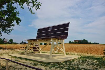 Built structure on field against sky