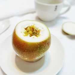 Close-up of lemon slice in plate on table