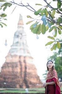 Woman in traditional clothing standing outdoors