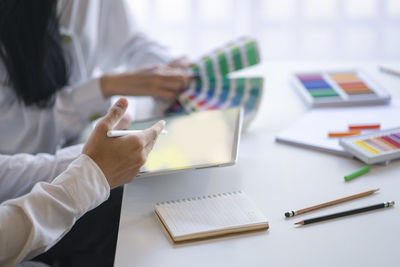 Midsection of woman working on table