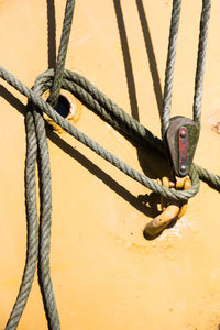 Close-up of rope tied to metal fence