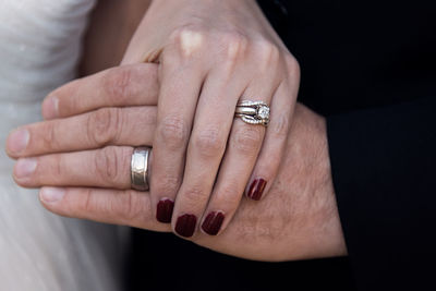 Close-up of couple holding hands, just married