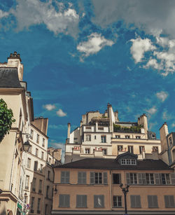 Low angle view of buildings in town against sky