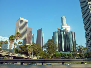 Low angle view of modern buildings against clear blue sky