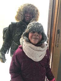 Portrait of smiling young woman in snow