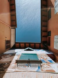 High angle view of swimming pool by building against sky